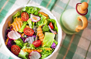 Salade de tomates et radis et une fausse huile d'olive sur la table